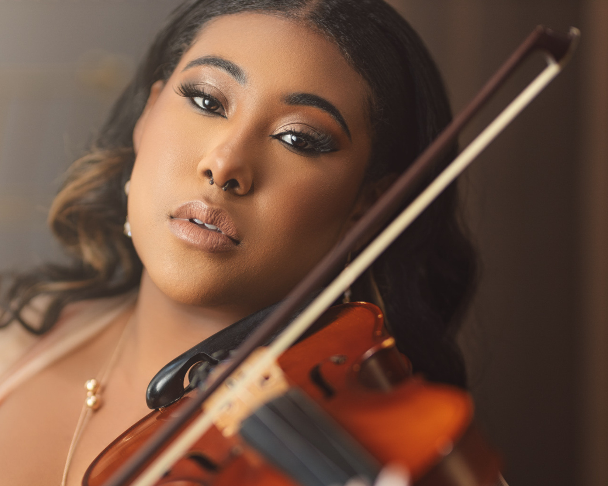 Portrait of a violinist with her violin and bow for the Obsession chapter