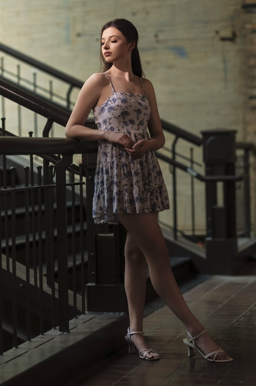 Senior girl in a floral dress on a staircase — one of the favorites from her gallery