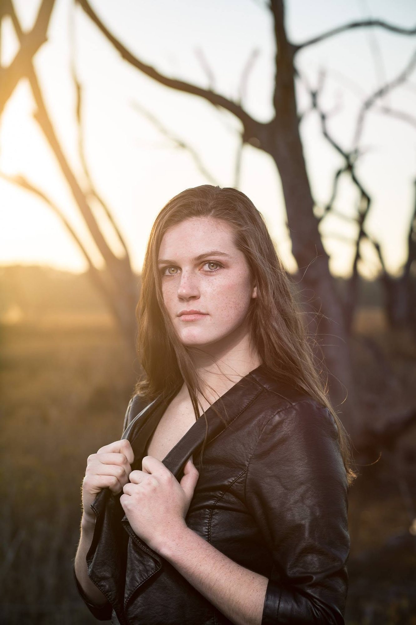 Senior girl in a leather jacket backlit at sunset — senior pictures, South Bend, Indiana