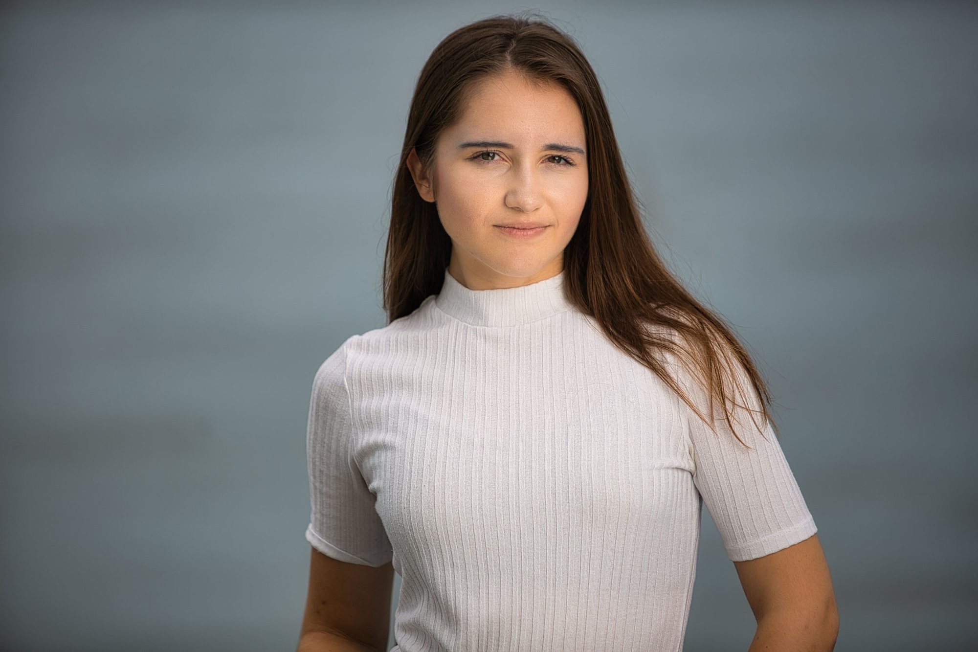 Senior girl in a white mock neck on a gray studio backdrop — senior portraits, South Bend, Indiana