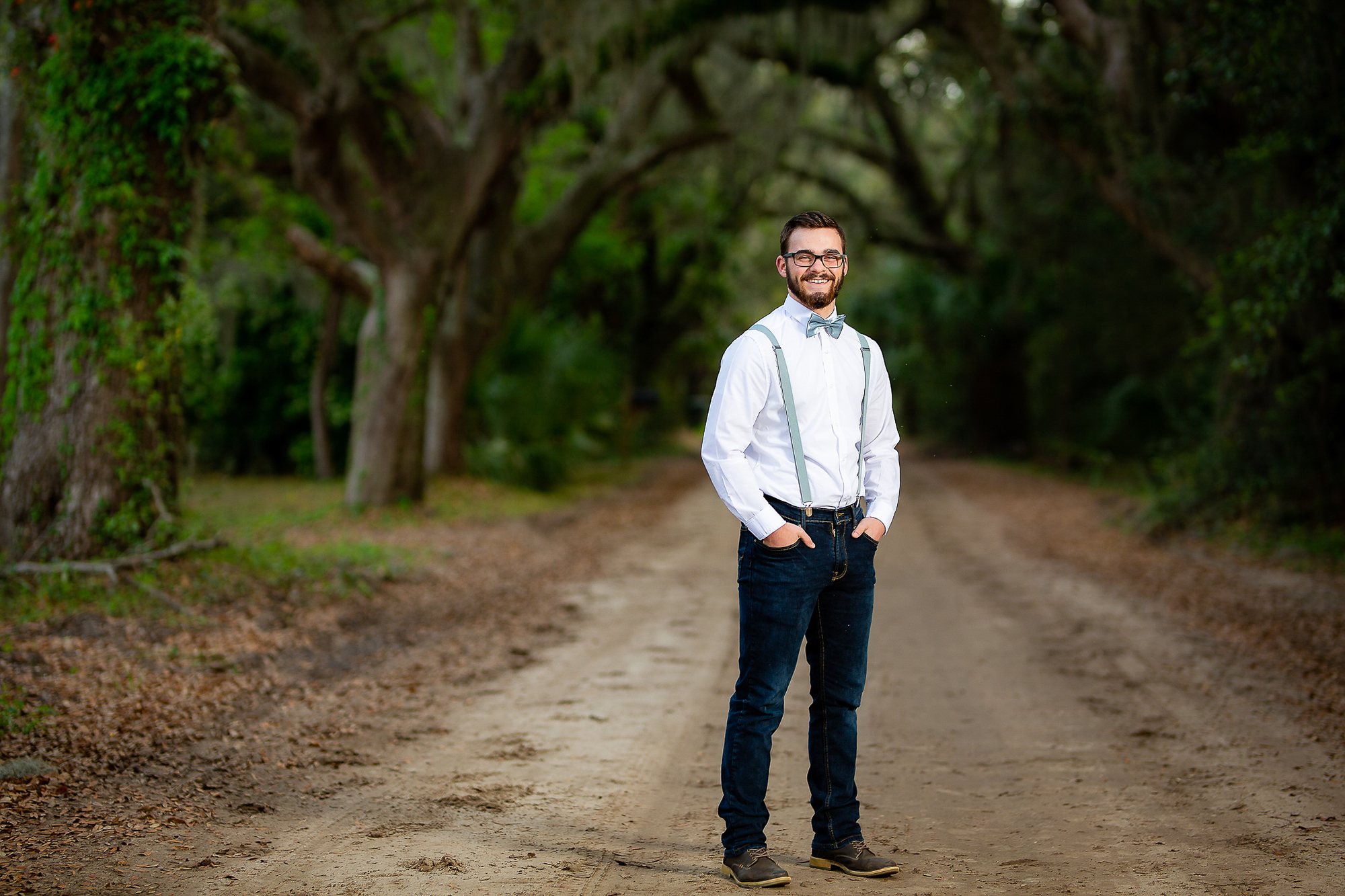 Senior guy in a white shirt and suspenders on a tree-lined lane — South Bend, Indiana