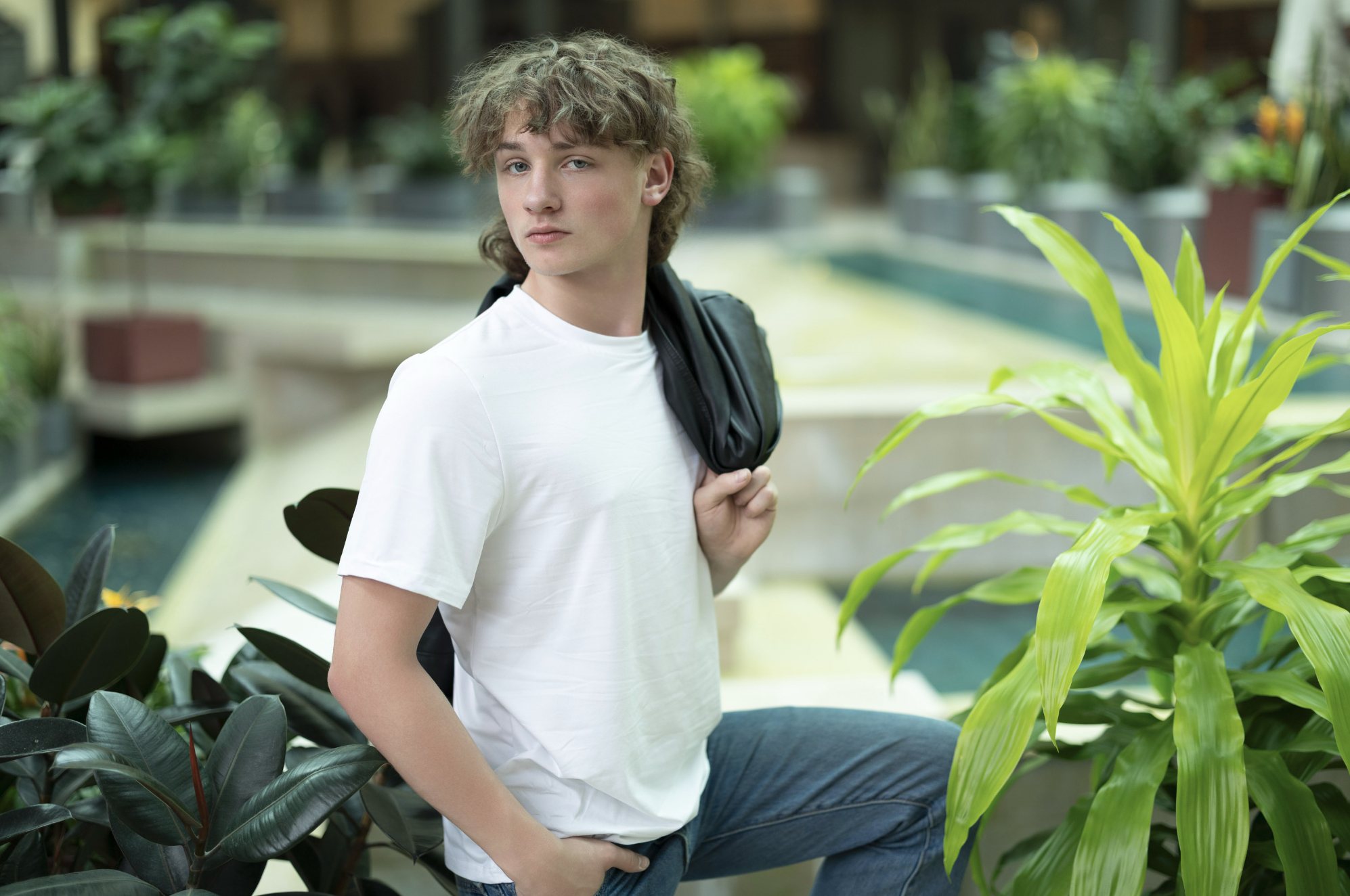 Senior guy in a white tee with a jacket over his shoulder — senior pictures, South Bend, Indiana